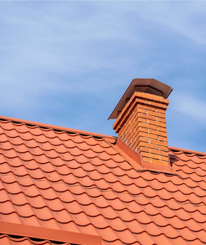 Expert chimney flashing integration on a tile roof in the Greater Bay Area, ensuring a watertight seal to prevent dry rot and extend the roof's lifespan.