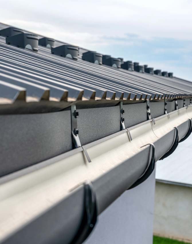 High-performance black metal gutter system installed in the Bay Area , designed to effectively manage water flow and prevent dry rot on the roof deck and fascia.
