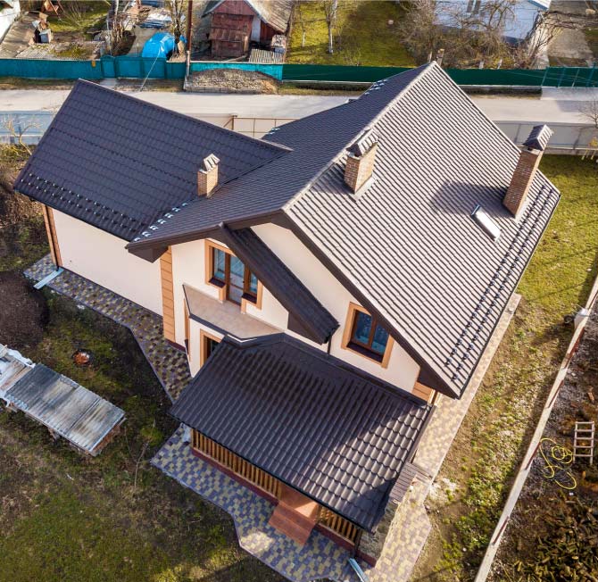 Aerial view of a complete roof system remodel in Vacaville featuring a durable dark tile roof installation by Capital Roofcare & Renovation, designed to withstand Greater Bay Area weather conditions.