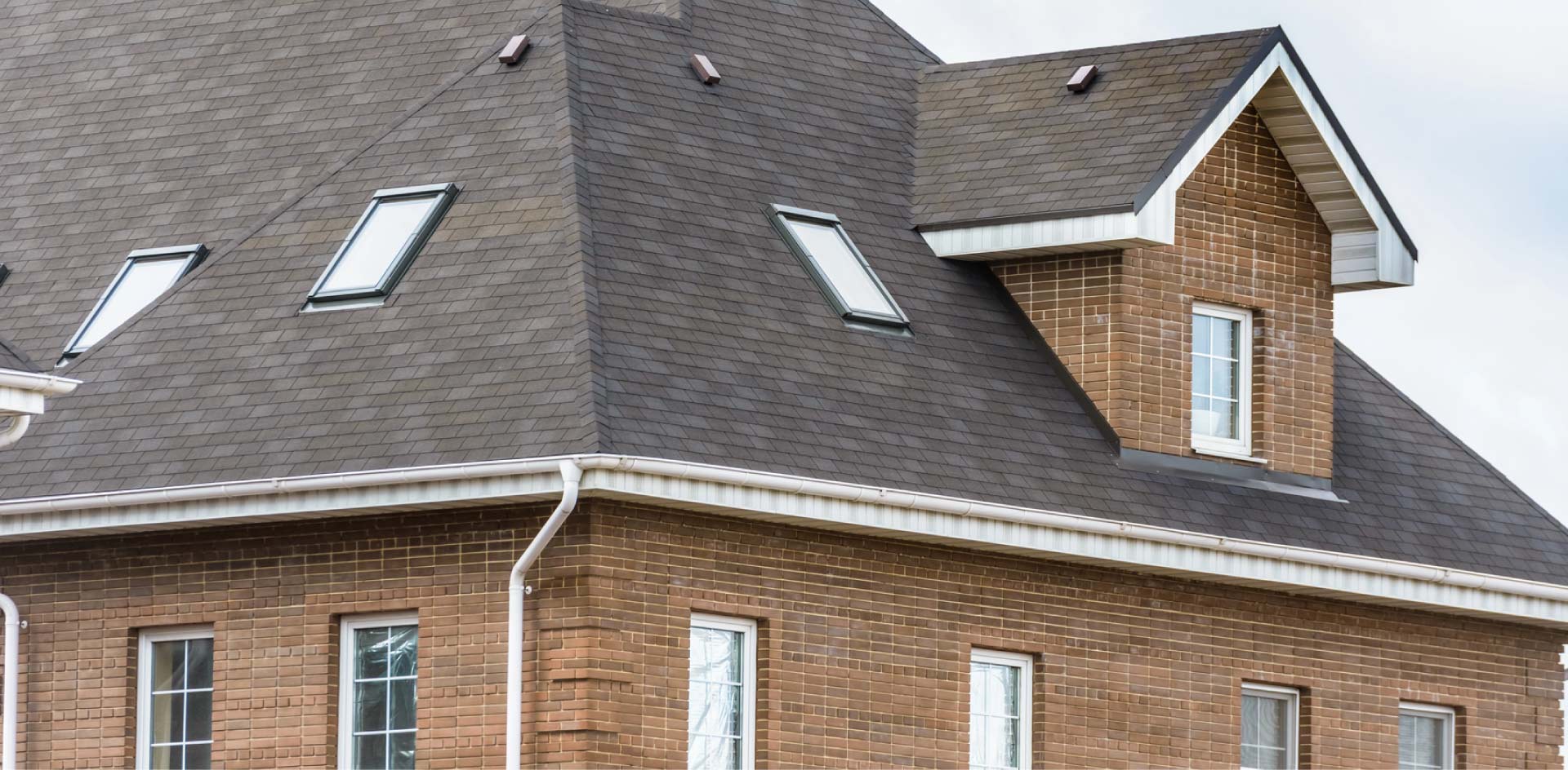 Single-story residential home with a brand new roof installation by the best roofing contractors, featuring a Capital Roofcare & Renovation yard sign