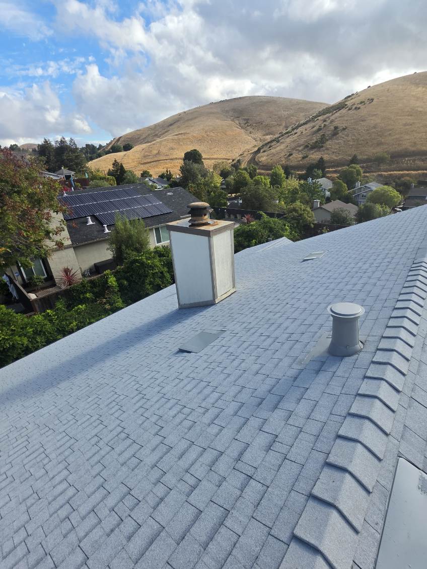 Detail-oriented roofing professional measuring composition shingles for a precise fit during a complete roof system remodel in the Sacramento area, demonstrating Capital Roofcare's commitment to quality.