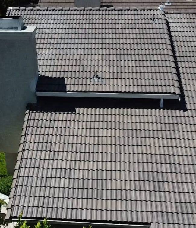 Expert chimney flashing integration on a tile roof in the Greater Bay Area, ensuring a watertight seal to prevent dry rot and extend the roof's lifespan.