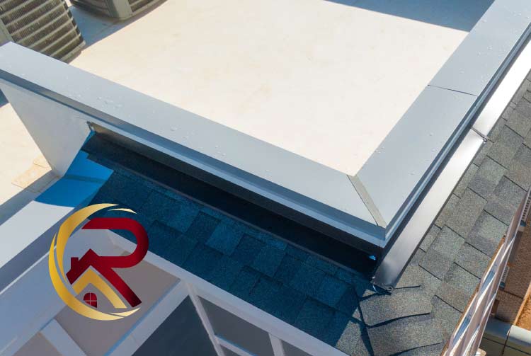 Close-up view of a newly installed white TPO flat roof section transitioning into a dark grey architectural asphalt shingle roof, highlighting the drip edge and parapet wall flashing, with a red and gold company logo.
