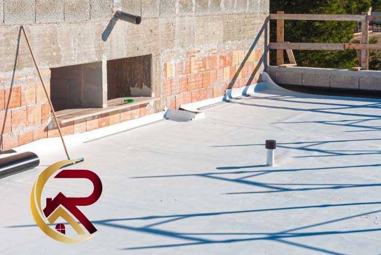 White TPO membrane roofing system partially installed on a flat roof deck with a brick parapet wall and an exposed ventilation pipe in the background, featuring a red and gold company logo in the bottom left.